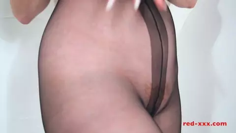 Red XXX fucks her dildo while in pantyhose